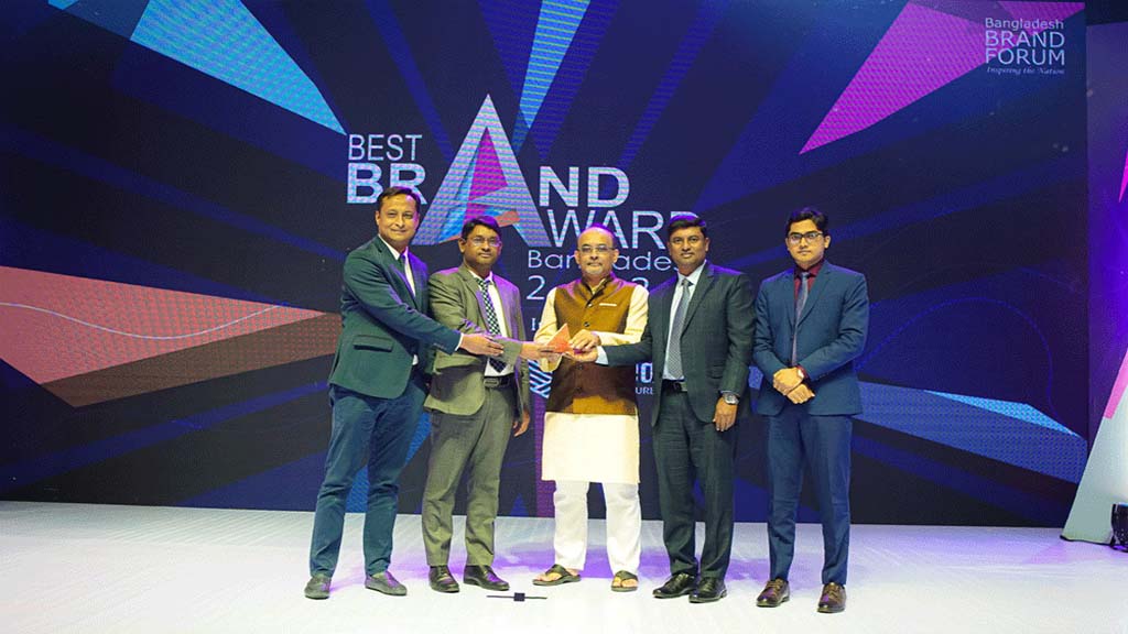 Iron Built team receiving the Best Brand Award on stage