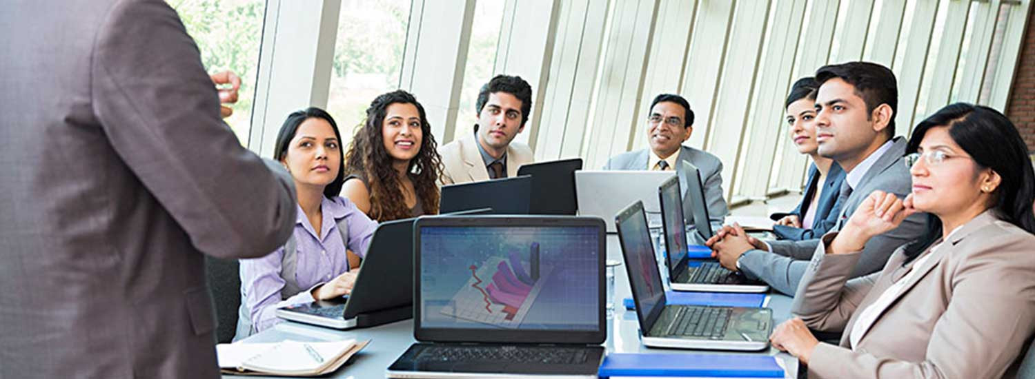 Colleagues in a training session around a meeting table